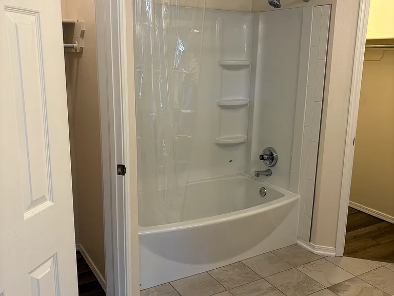 Master bath with tile, tub & shower surround. Two walk-in closets.