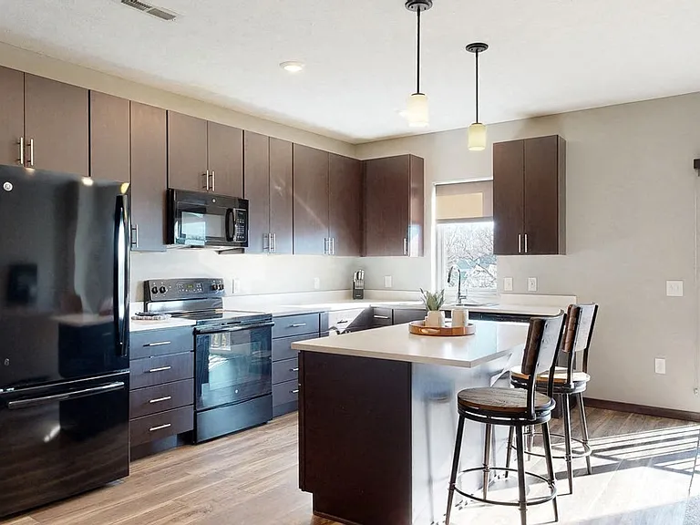 A modern kitchen with rich cabinetry and sleek finishes makes every meal feel like an experience.