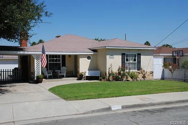 Note the cute porch and mature roses