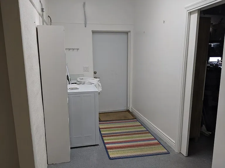 Private laundry room, off of enclosed storage area.