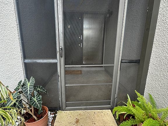 Screened in covered area to front door.