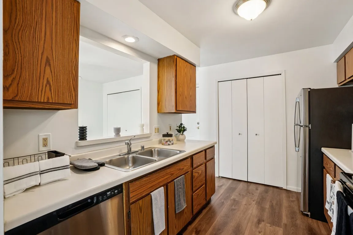 Well-appointed kitchens offer wood cabinetry and stainless steel dishwashers for modern convenience, professionally operated by Highlands Vista Group.