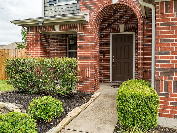 A quaint sidewalk leads you to the covered arched front porch!