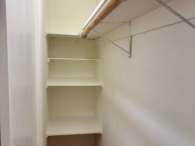 Deep closet with storage shelves