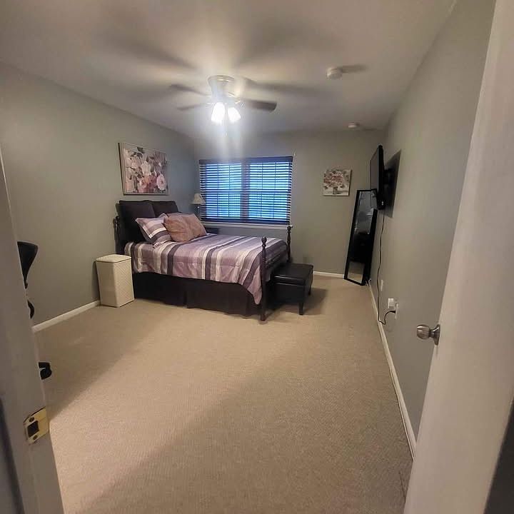 Spacious and fully furnished bedroom with ceiling fan.