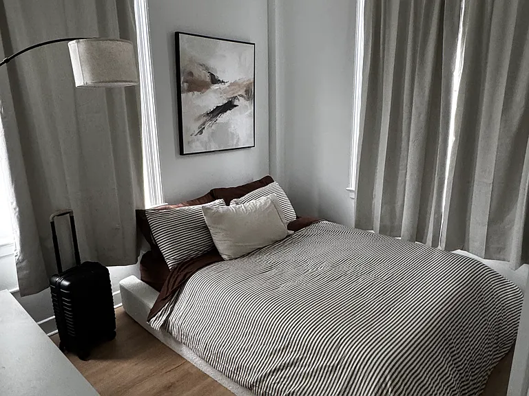 The bedroom features multiple windows that fill the space with natural light, a generously sized closet, and its own climate-control system for personalized comfort.