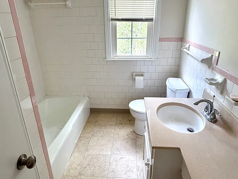 Hall bathroom upstairs with a cast iron tub and shower