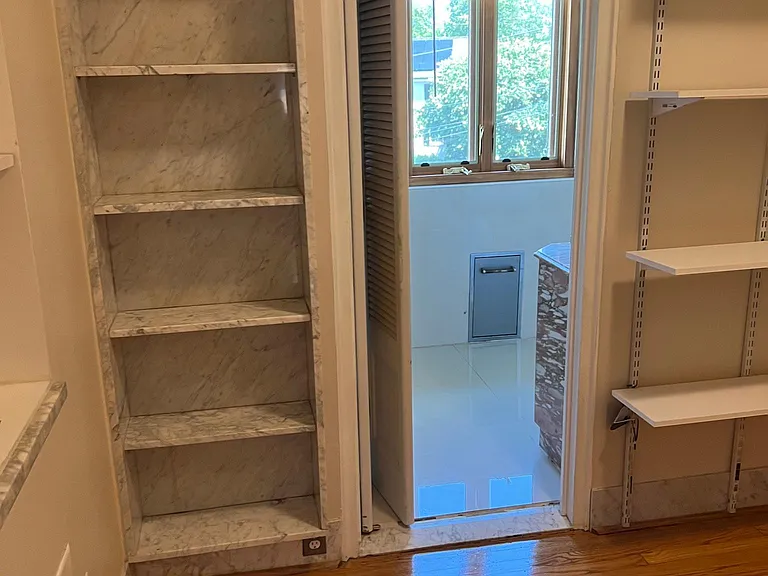 master bedroom walk-in closet showing master bathroom entrance bookshelves, and adjustable clothes shelves