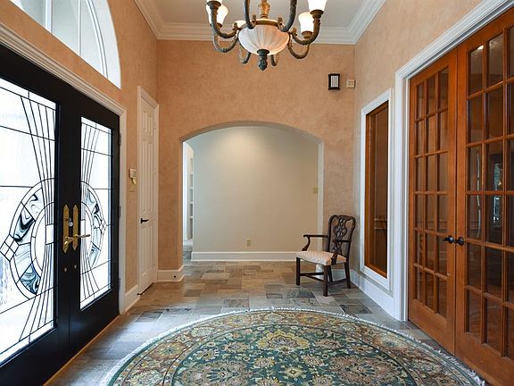 Gorgeous front doors lead into this stunning entry hall.