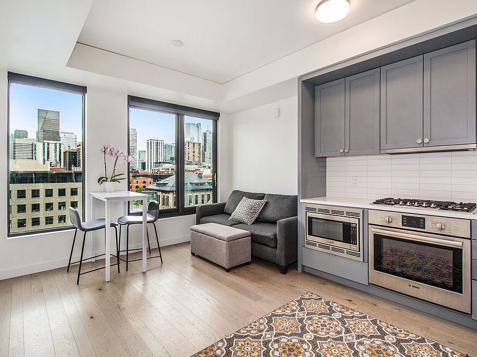 Beautiful living area and kitchen. Eat dinner while enjoying views of Union Station and downtown! Stainless steel appliances. Furnishing is optional. Couch, ottoman, table and chairs available at request.