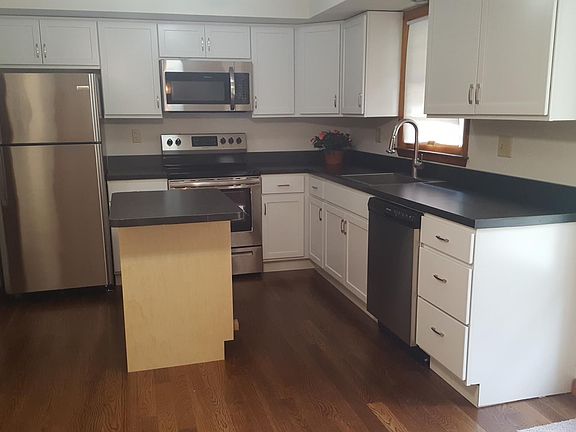 kitchen has electric stove, dishwasher, refrigerator, microw