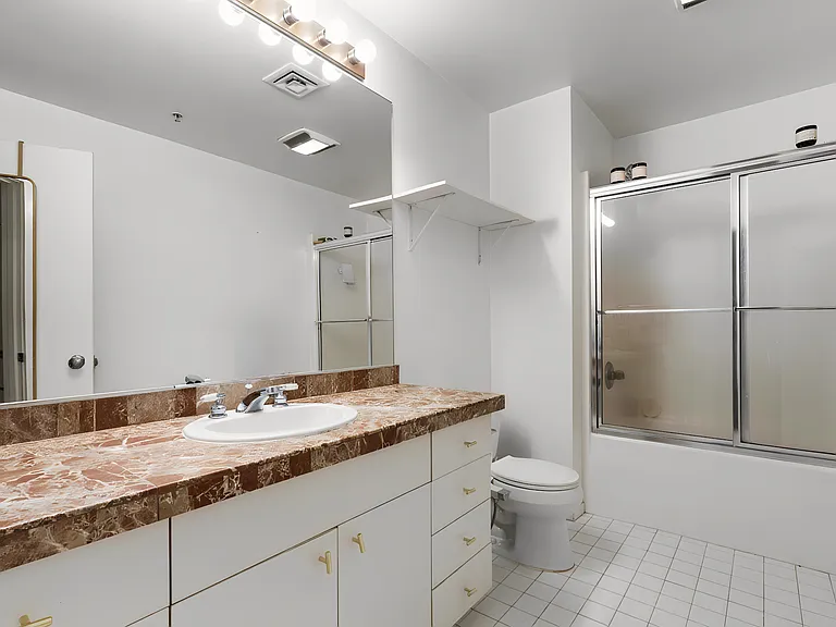 Bathroom with storage and drawers.