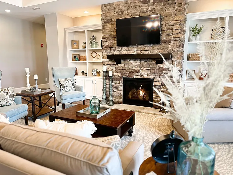 The Berkeley's Clubhouse offers a spacious lounge area with beautiful built in craftsman bookshelves, gas fireplace, and 66" TV.
