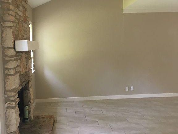 Living Room with Working Fireplace, Vaulted Ceilings, and Crown Molding