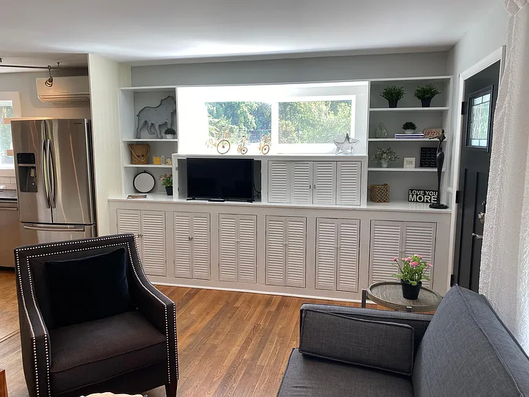 Lots of storage in built in cabinets, hidden bar area in cabinet next to TV. House comes fully furnished.