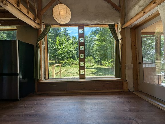 Picture windows let in all the sunlight and look out to the yard and garden.