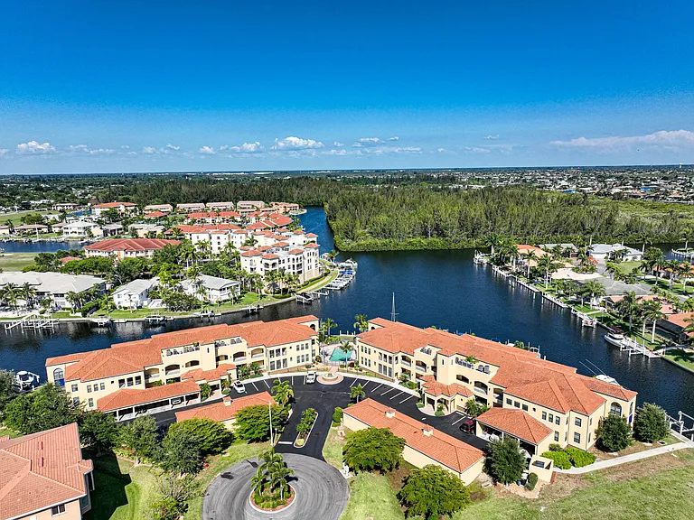 Aerial from west looking east at entrance drive and turning basin beyond. Deep water canals lead out to Charlotte Harbor and the Gulf.