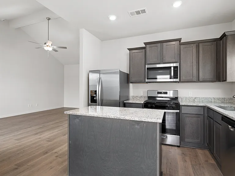 The kitchen has stainless steel appliances.
