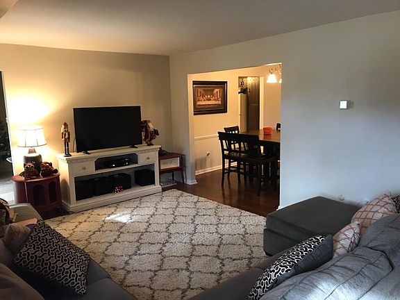 Living room w/ view into dining area
