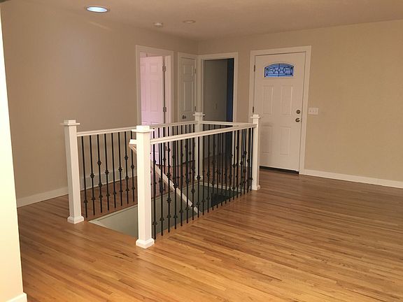 Front door and stairway to basement