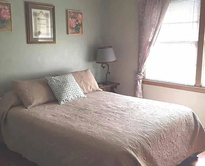 Bedroom w large closet, two windows, wood floors