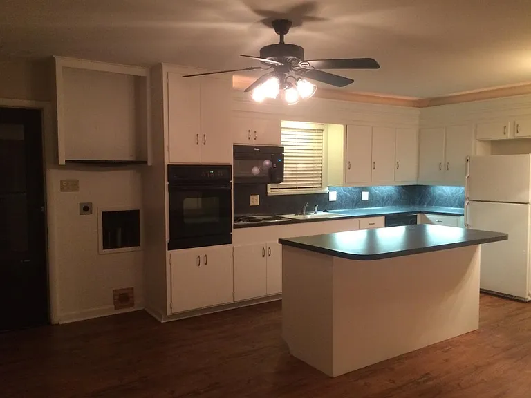 Stackable washer and dryer in kitchen if wanted (shown in next photo). Kitchen island is moveable. Stainless steel refrigerator if wanted.