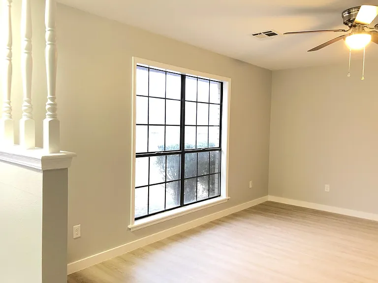 New light fixtures and ceiling fans, flooring and paint . Wonderful natural light with floor to ceiling windows in living area