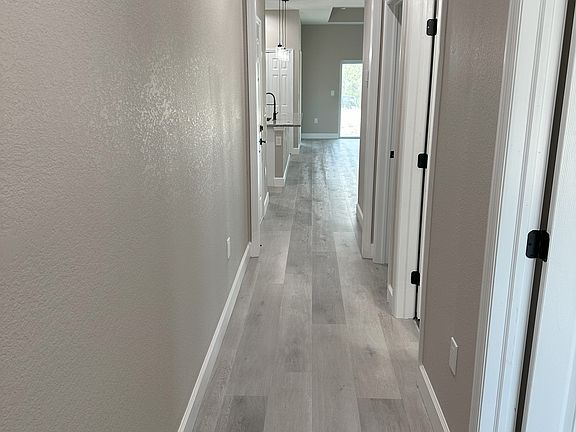 Entry walk-in. First door leads to bedroom1, second door to bathroom, third door to bedroom2 and then kitchen/living room