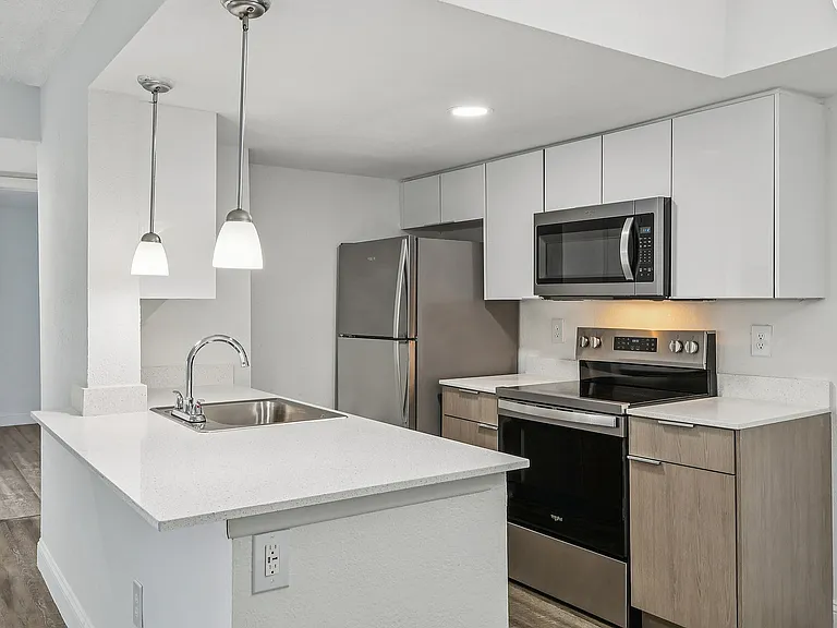 Kitchen with Quartz Counter tops and Dual-Tone Cabinets