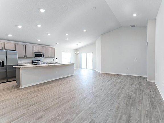 The gathering room is fully open to the kitchen and cafe, which opens up to outdoor living on your c