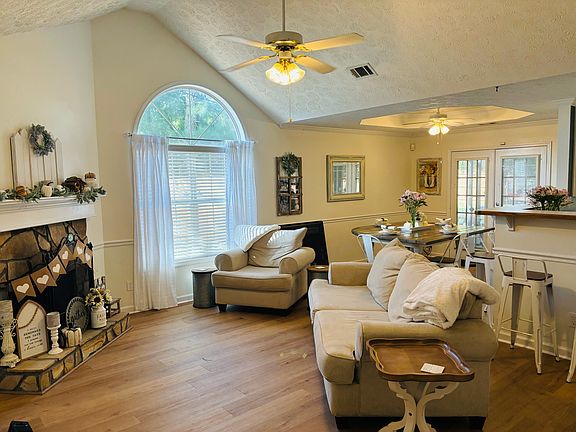 Vaulted living room with fireplace for cozy evenings (furniture not included)
