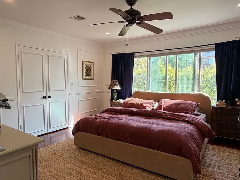 Extremely large primary bedroom with large closet and ceiling fan
