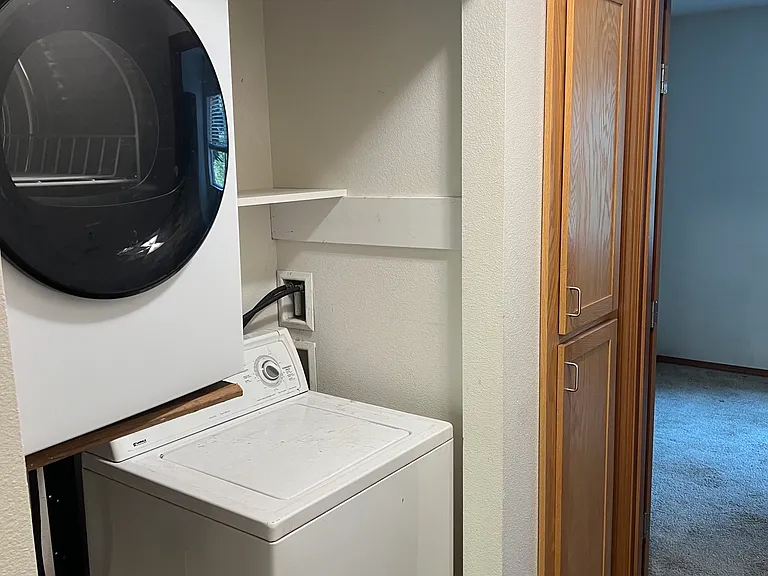 laundry between main floor bedroom and linen closet