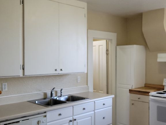 Large kitchen includes new dishwasher and newer oven. Floor to ceiling window overlooking backyard.