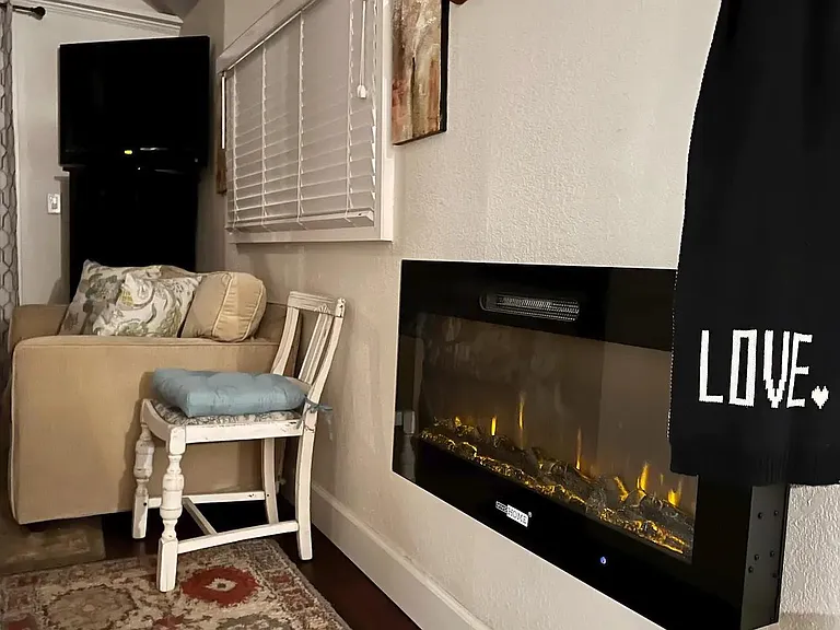 Electric fireplace in hallway that heats the whole cabin.