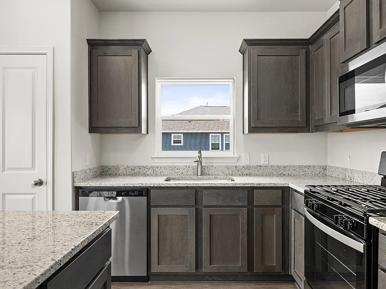 The kitchen has beautiful wood cabinetry.