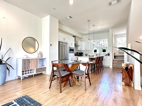 2nd floor common area includes kitchen, island, dining room, living room, all within an open space concept.