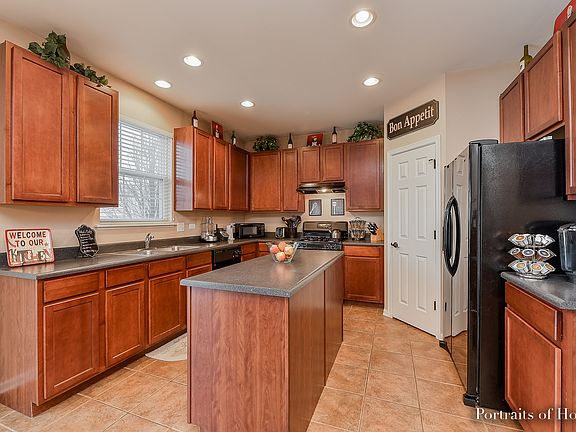 Gorgeous 42" cherry stained maple cabinetry, ceramic tile flooring, recessed lighting & walk-in pant