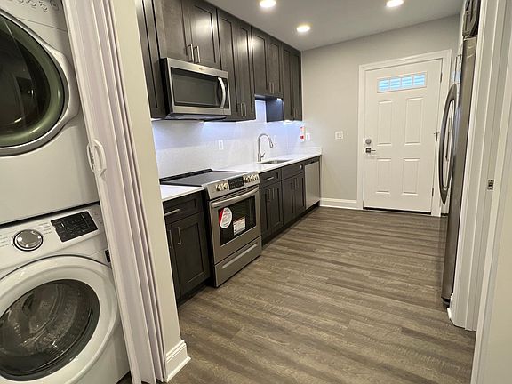 Full size kitchen, with full-size stackable washer and dryer.