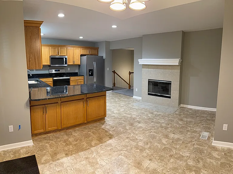 Country kitchen with see-through gas fireplace to the Great Room.
