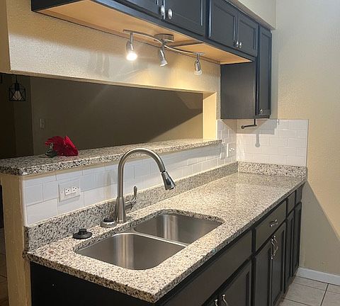 kitchen with granite countertops and double sink