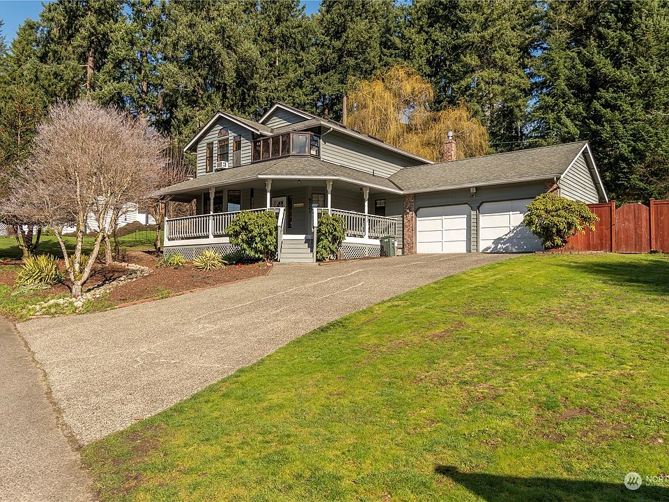 Edgewood. WA Traditional two story home with wrap around front porch. Plenty off street parking, also neighborhood has a overflow parking area. Home sits on a corner lot. White dogwood tree in front of home almost ready to bloom.>