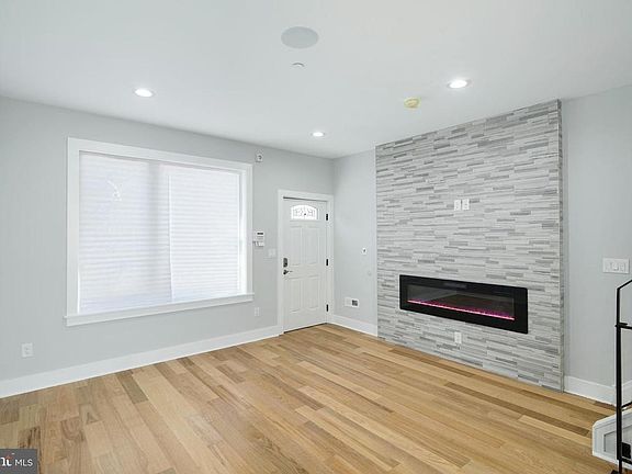Both the front and back of the house have large windows, letting in plenty of natural light. There is also a gas fireplace feature with heating element and Bluetooth speakers wired throughout each room in the ceilings.