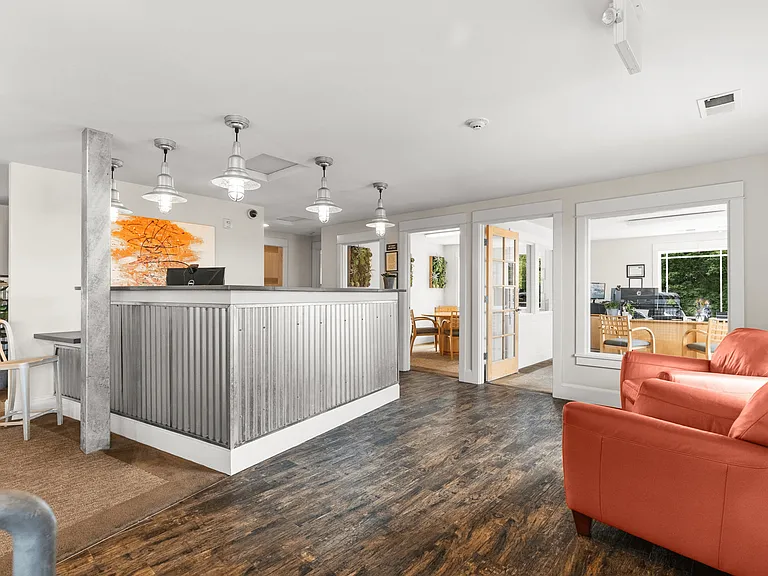 Modern leasing office with welcoming seating and a bright, open layout.