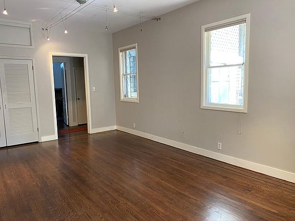 Living room area with large storage closet and view of entry hall. Entry hall has its own coat closet! Lots of storage!