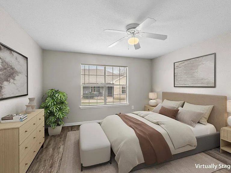 Cozy bedroom with ample space at Crescent Village Apartments in Elgin, TX