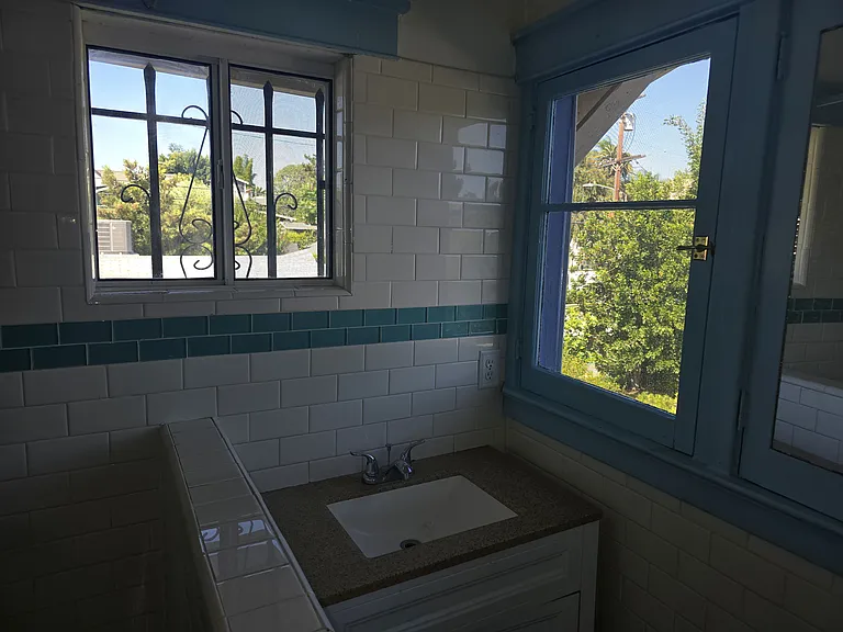 Sink area with Windows looking outdoors