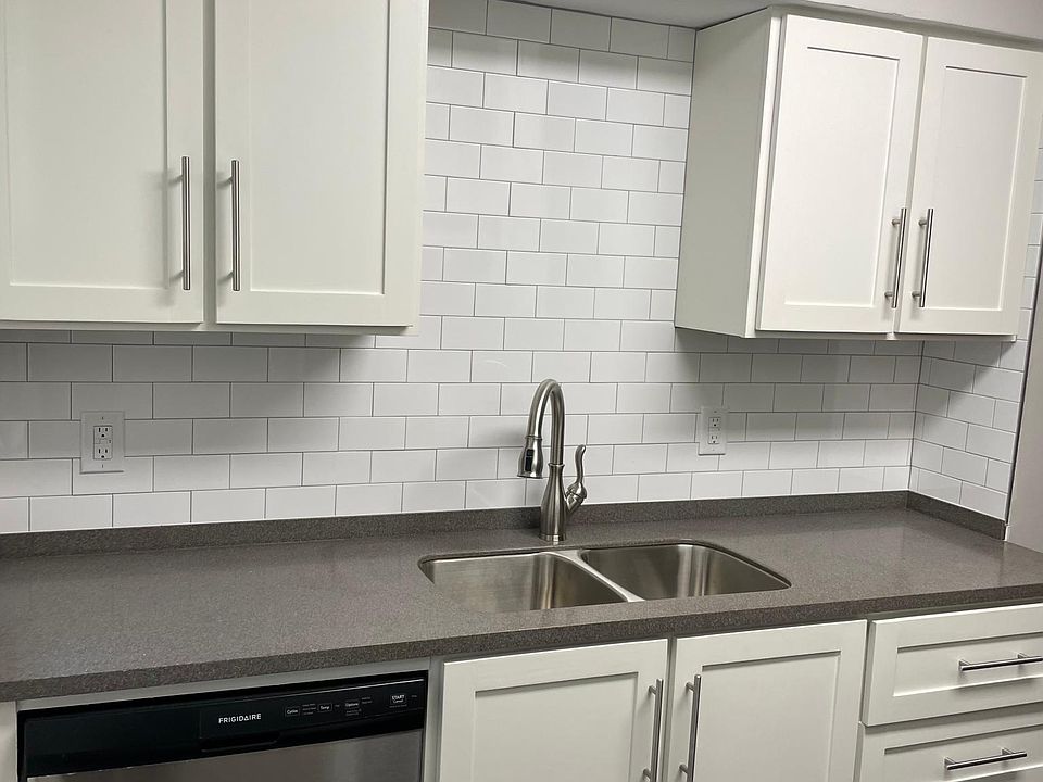 New kitchen with dishwasher, soft close cabinets, and solid surface countertop.