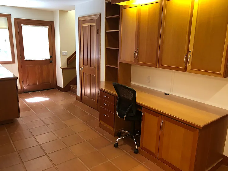 Downstairs work area where family room, 3 bedroom, family room and bathroom are located