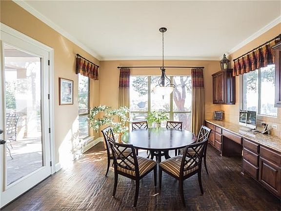 Adorable and bright breakfast area with hand-scraped wood flooring and easy access to backyard